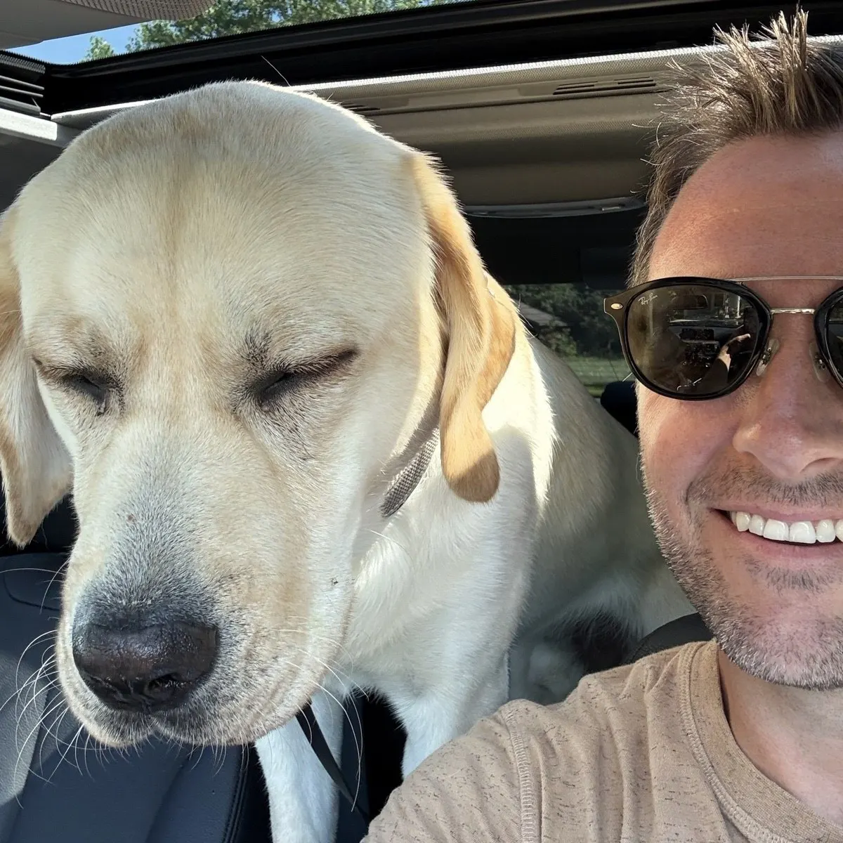 Ryan and a yellow lab in the car