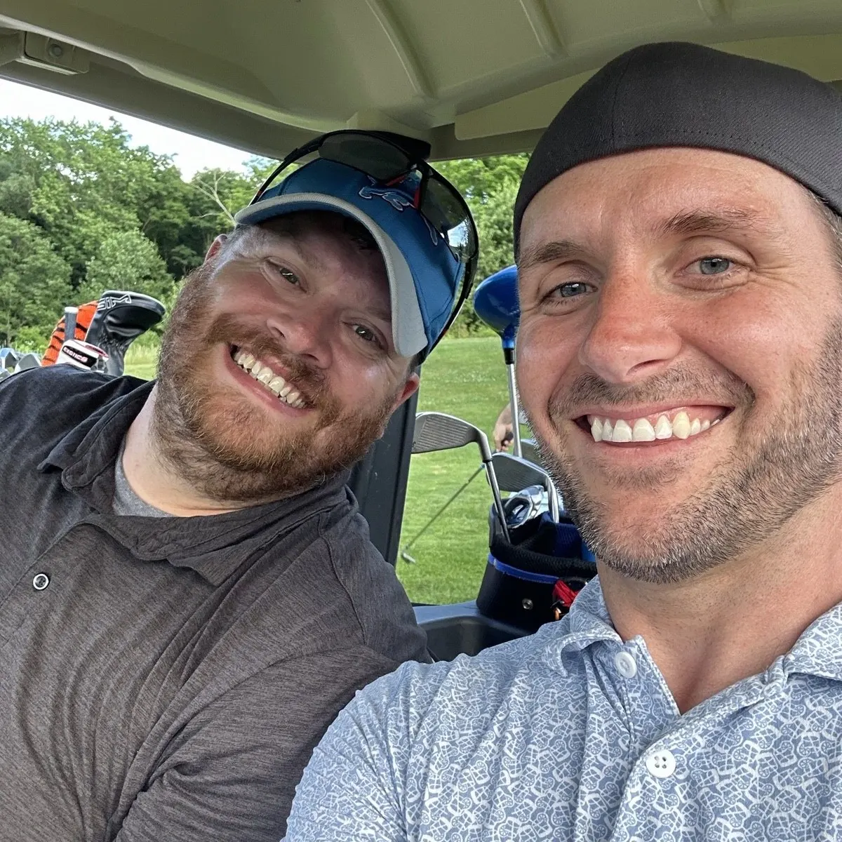 Ryan and a friend in a golf cart